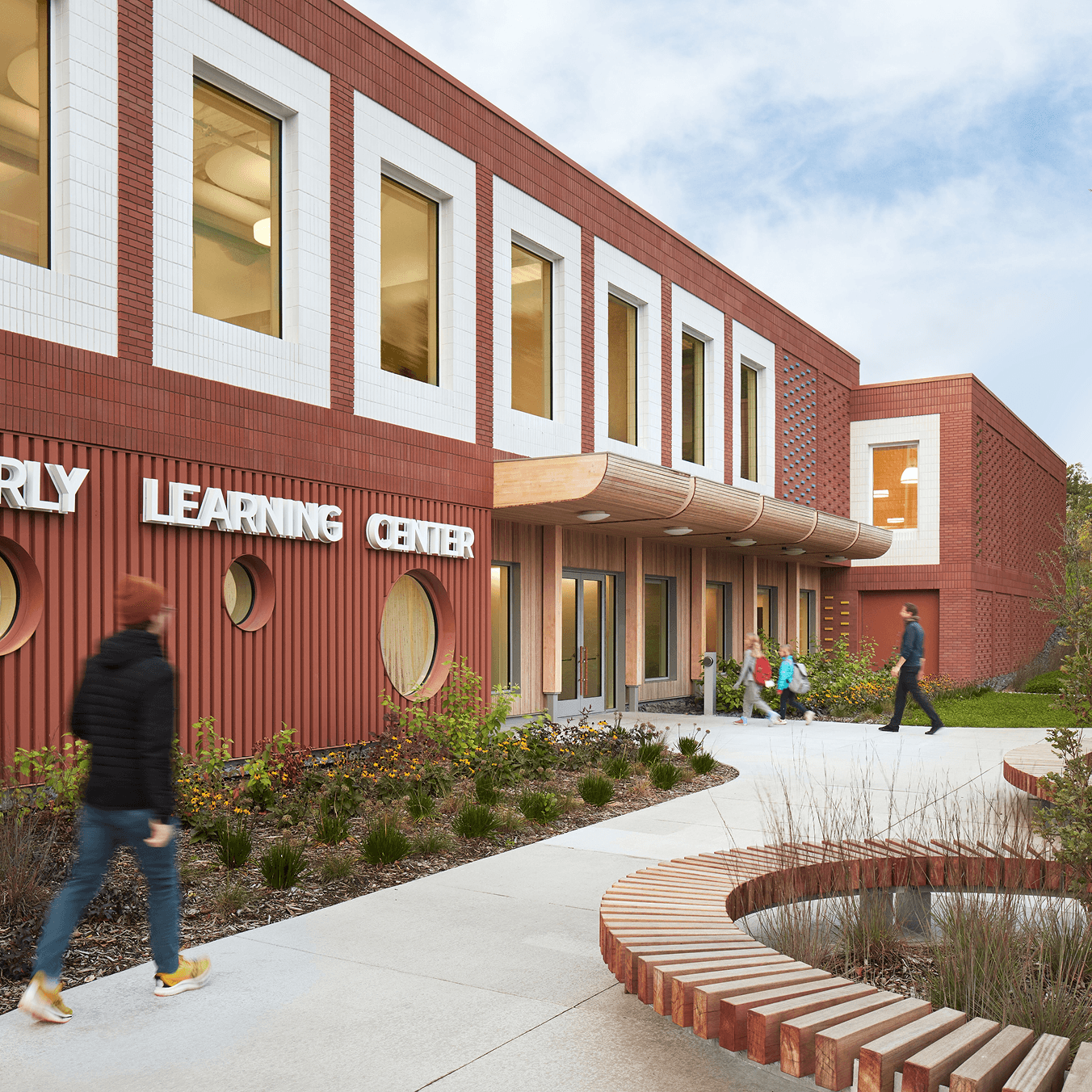 School exterior featuring students walking in through a Marvin Ultimate Commercial Door.