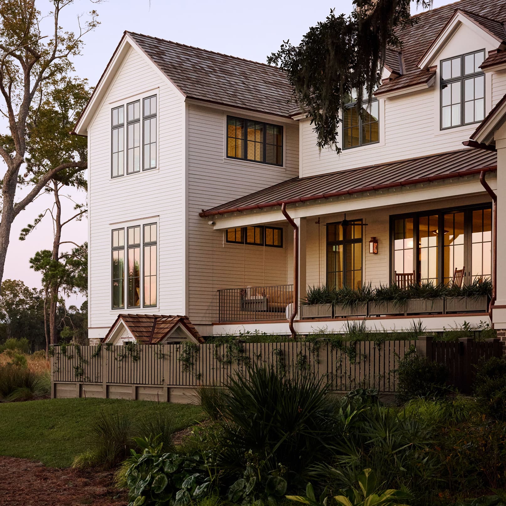 White home exterior with large Marvin Elevate Awning and Casement windows with divided lites.
